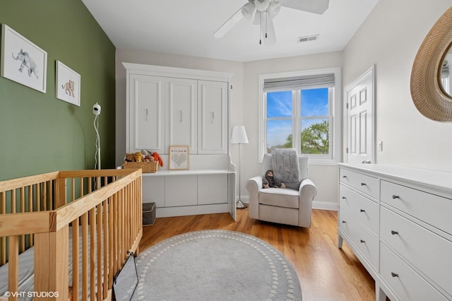 1717 W Newport Ave Unit 5, Chicago, IL 60657 - bedroom with a crib, light wood finished floors, and ceiling fan