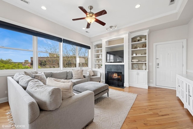 1717 W Newport Ave Unit 5, Chicago, IL 60657 - living area with ceiling fan, a tiled fireplace, light wood-style floors, recessed lighting, and ornamental molding