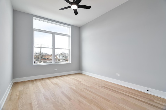 3450 N Central Ave, Chicago, IL 60634 - spare room featuring light wood-style floors, a ceiling fan, and baseboards