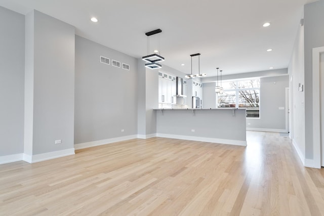3450 N Central Ave, Chicago, IL 60634 - unfurnished living room featuring light wood-type flooring, recessed lighting, and baseboards