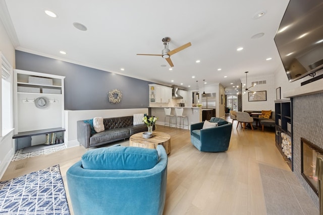 1924 N Wolcott Ave, Chicago, IL 60622 - living room featuring a ceiling fan, light wood-type flooring, a chandelier, ornamental molding, and recessed lighting