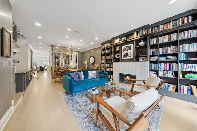 1924 N Wolcott Ave, Chicago, IL 60622 - living area with a lit fireplace, wood finished floors, crown molding, and recessed lighting