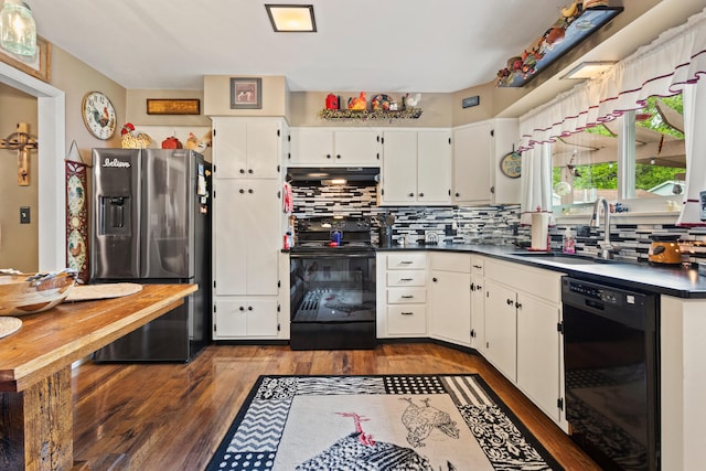 503 E Cedar Ln, Monticello, IL 61856 - kitchen with black appliances, a sink, dark wood-style flooring, dark countertops, and tasteful backsplash