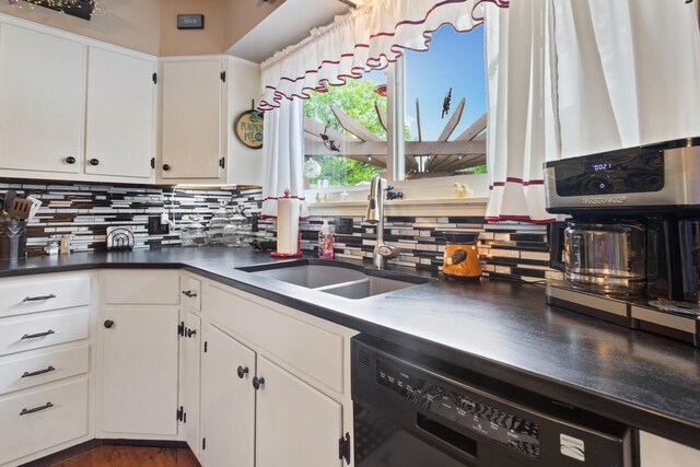 503 E Cedar Ln, Monticello, IL 61856 - kitchen featuring dishwasher, a sink, decorative backsplash, and white cabinets