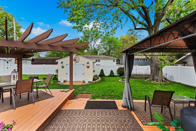 503 E Cedar Ln, Monticello, IL 61856 - view of patio featuring a deck, outdoor dining space, a shed, an outbuilding, and a pergola