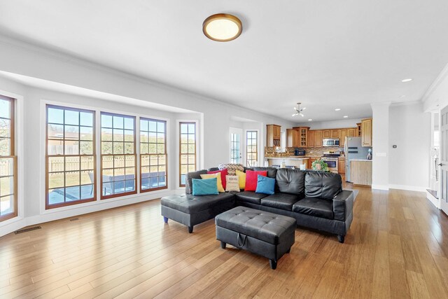 118 Jack Dylan Dr, Hampshire, IL 60140 - living room with recessed lighting, ornamental molding, a healthy amount of sunlight, and light wood-type flooring