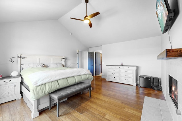 118 Jack Dylan Dr, Hampshire, IL 60140 - bedroom with a ceiling fan, a lit fireplace, light wood-style flooring, and lofted ceiling