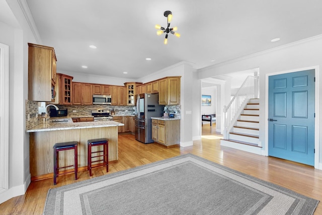 118 Jack Dylan Dr, Hampshire, IL 60140 - kitchen with appliances with stainless steel finishes, tasteful backsplash, a sink, a peninsula, and glass insert cabinets