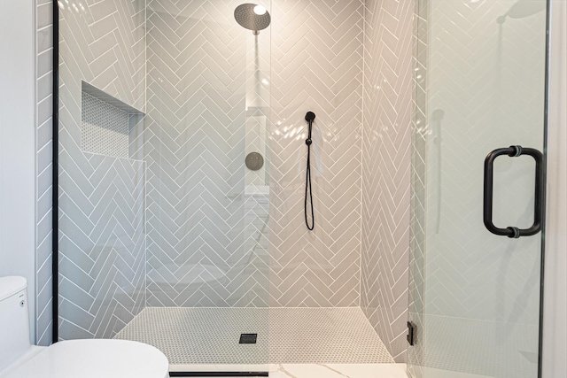 full bath featuring toilet and a shower stall