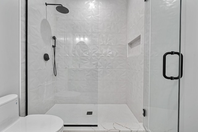 bathroom with toilet and a stall shower