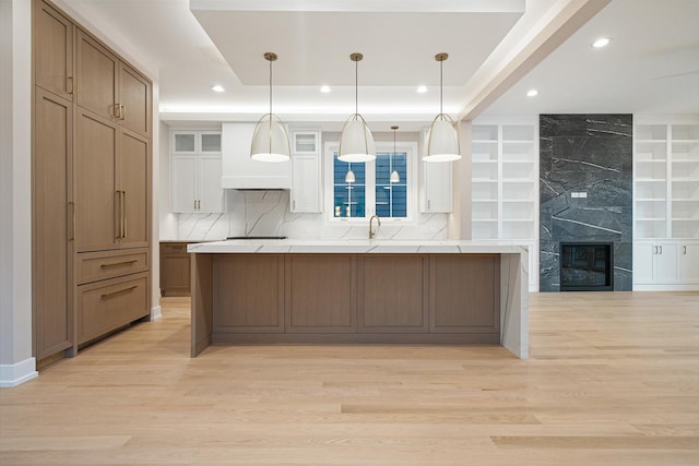 kitchen with light countertops, recessed lighting, a large island, and light wood-style floors