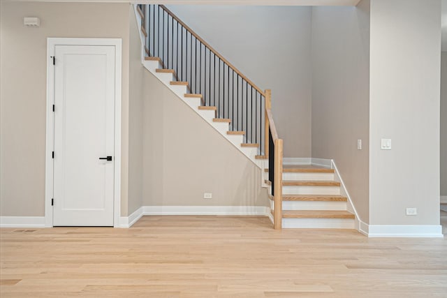 stairs with baseboards and wood finished floors