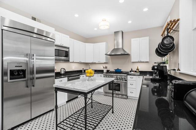 900 W Lakeside Pl Unit 2, Chicago, IL 60640 - kitchen featuring built in appliances, recessed lighting, wall chimney exhaust hood, and white cabinetry