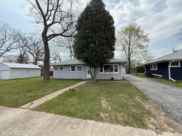 view of front of property with an outbuilding and a front lawn