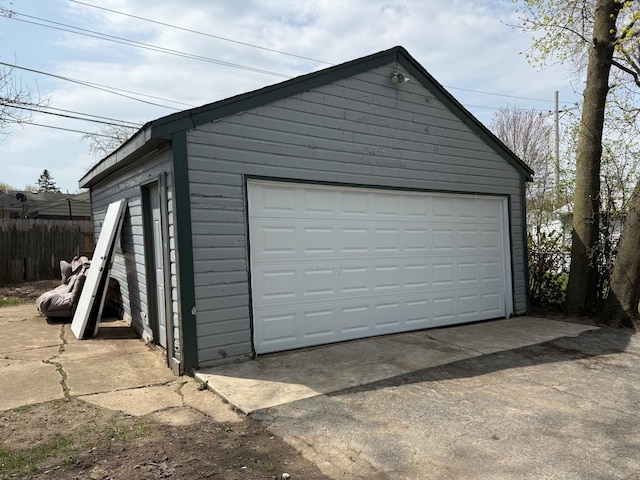 detached garage featuring fence