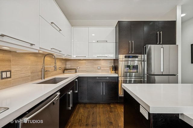 2109 N Campbell Ave Unit 2N, Chicago, IL 60647 - kitchen with stainless steel appliances, a sink, modern cabinets, dark cabinetry, and light countertops
