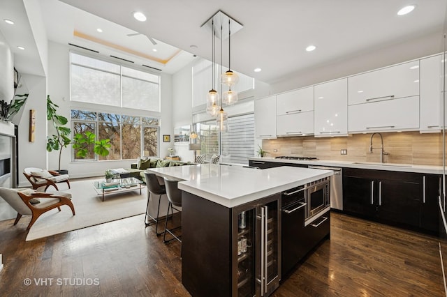 2109 N Campbell Ave Unit 2N, Chicago, IL 60647 - kitchen featuring a sink, wine cooler, white cabinetry, modern cabinets, and a towering ceiling