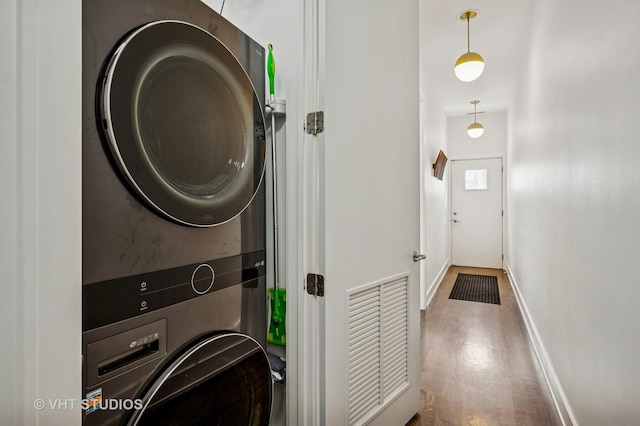2109 N Campbell Ave Unit 2N, Chicago, IL 60647 - washroom featuring stacked washing machine and dryer, wood finished floors, and baseboards