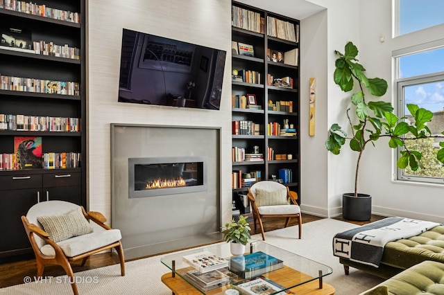 2109 N Campbell Ave Unit 2N, Chicago, IL 60647 - living area with a glass covered fireplace, baseboards, built in shelves, and wood finished floors