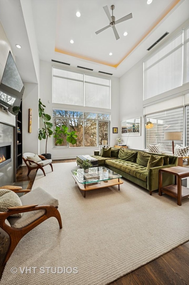 2109 N Campbell Ave Unit 2N, Chicago, IL 60647 - living area featuring wood finished floors, a high ceiling, a glass covered fireplace, ceiling fan, and recessed lighting