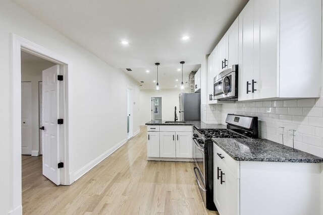 2437 W Taylor St, Chicago, IL 60612 - kitchen with appliances with stainless steel finishes, white cabinets, decorative backsplash, a peninsula, and recessed lighting