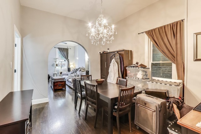 2437 W Taylor St, Chicago, IL 60612 - dining room featuring arched walkways, dark wood-type flooring, and a chandelier