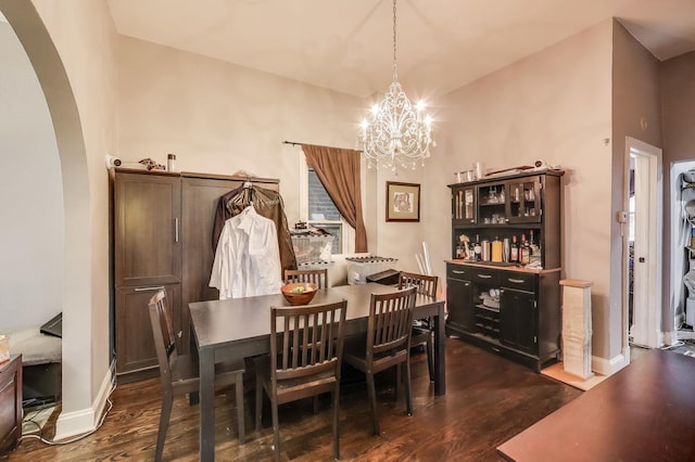 2437 W Taylor St, Chicago, IL 60612 - dining room featuring arched walkways, dark wood-style flooring, and a chandelier