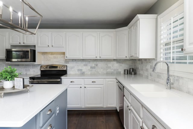kitchen featuring light countertops, white cabinetry, appliances with stainless steel finishes, and a sink