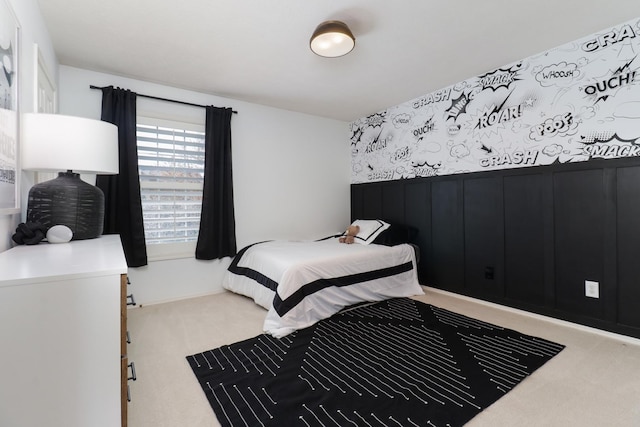 bedroom with carpet and a wainscoted wall