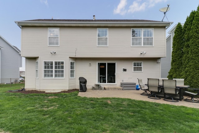 back of property featuring a lawn and a patio