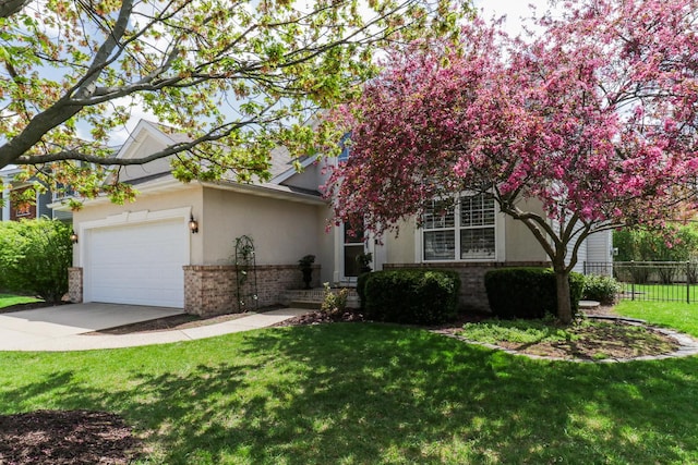 view of front facade with brick siding, fence, driveway, and stucco siding