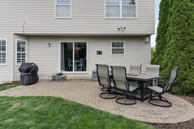 back of property featuring a patio and outdoor dining space