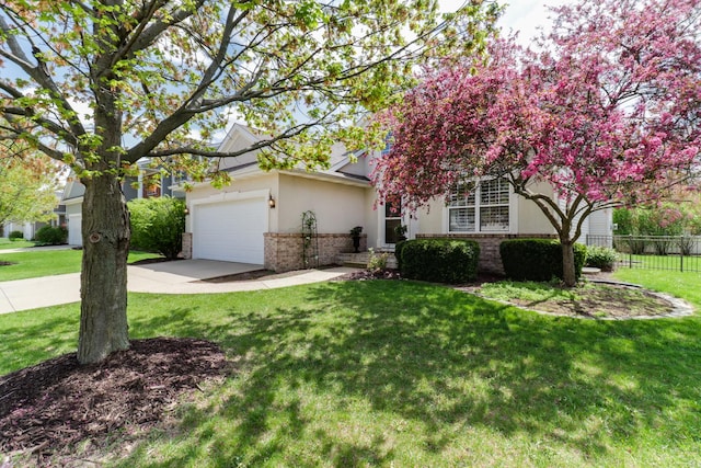 view of property hidden behind natural elements featuring fence, brick siding, a garage, a front yard, and driveway