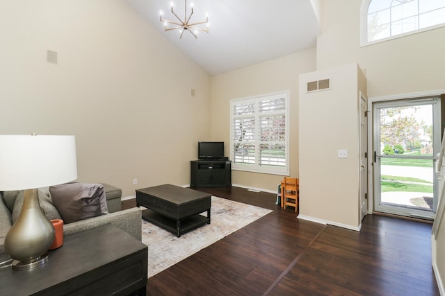 living area featuring visible vents, high vaulted ceiling, baseboards, dark wood-style floors, and an inviting chandelier