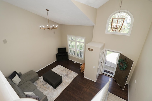 entrance foyer featuring visible vents, wood finished floors, a notable chandelier, and high vaulted ceiling