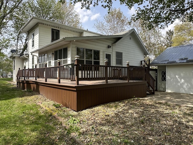 rear view of house featuring a wooden deck