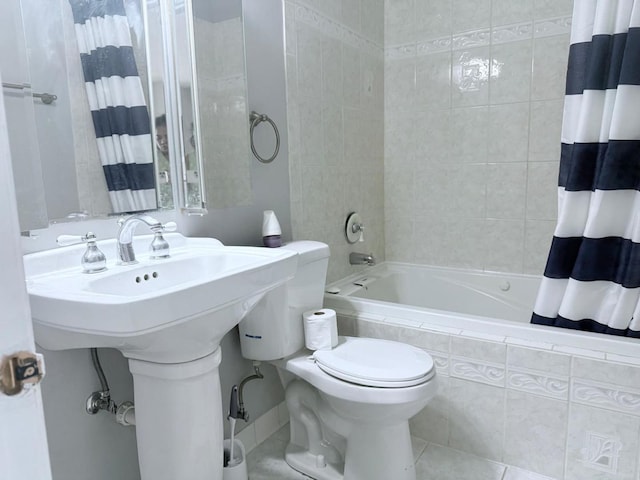 full bath featuring tile patterned floors, tiled shower / bath, and toilet