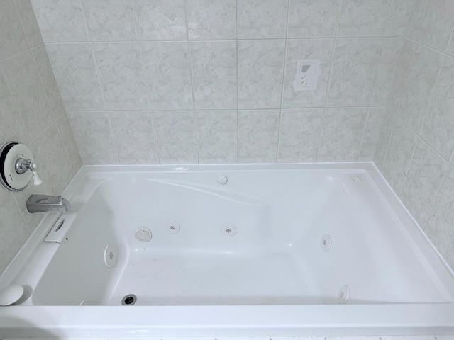 full bath featuring a tub with jets