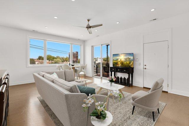 living area featuring baseboards, ceiling fan, recessed lighting, and wood finished floors