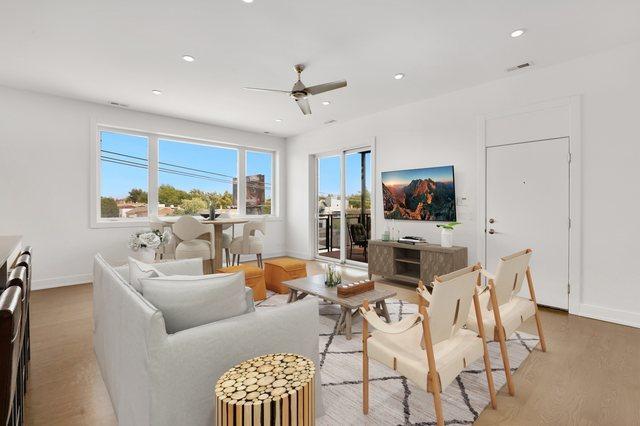 living area with recessed lighting, baseboards, a ceiling fan, and light wood-type flooring