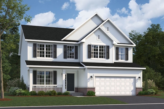 traditional-style house with a porch, an attached garage, driveway, and a front yard