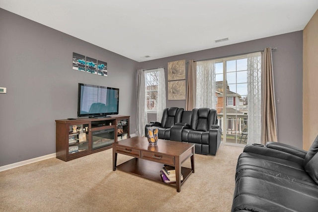 carpeted living area with visible vents and baseboards