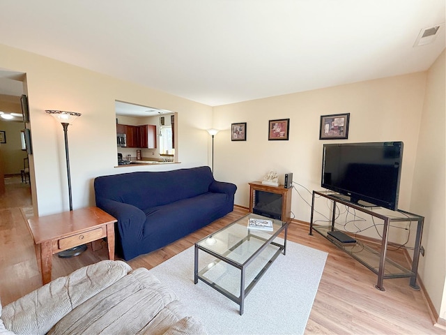 living room with light wood finished floors and baseboards