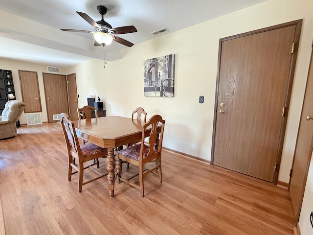 dining space featuring light wood-style flooring, ceiling fan, and baseboards