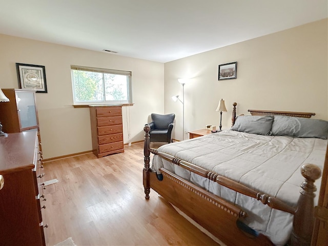bedroom featuring light wood-type flooring and baseboards
