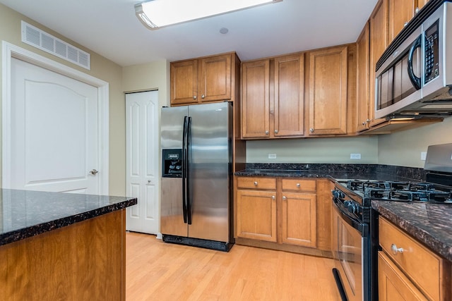 855 E 22nd St Unit 105, Lombard, IL 60148 - kitchen with light wood-style floors, appliances with stainless steel finishes, brown cabinets, and visible vents