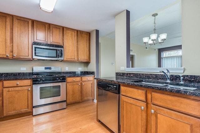 855 E 22nd St Unit 105, Lombard, IL 60148 - kitchen with a sink, stainless steel appliances, brown cabinets, and light wood-style flooring