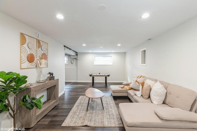 living area featuring recessed lighting, baseboards, and dark wood-style flooring