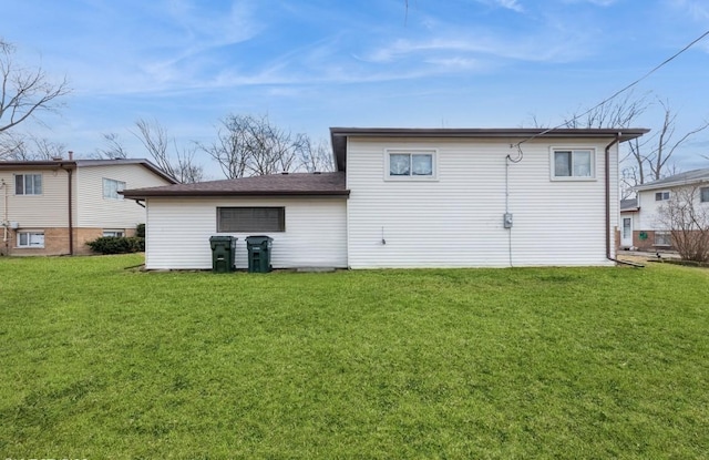 rear view of property with a lawn
