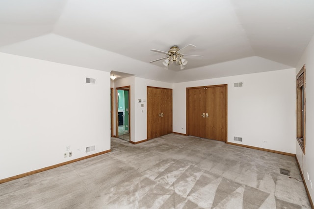 unfurnished bedroom with vaulted ceiling, baseboards, light colored carpet, and ceiling fan